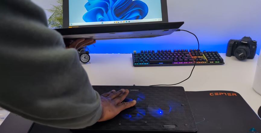 Laptop placed on an external cooling pad for extra airflow