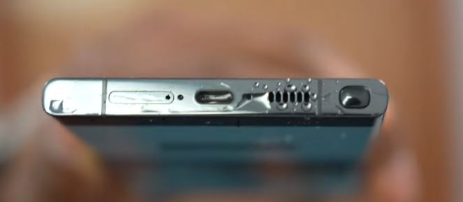 Water droplets being ejected from the phone speaker while the tone plays